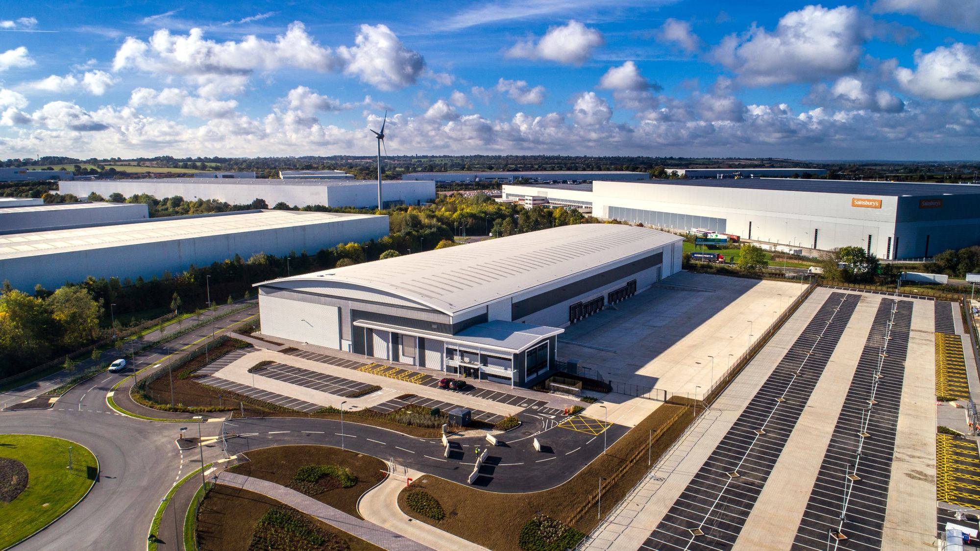 New distribution warehouse on a logistics park under blue skies