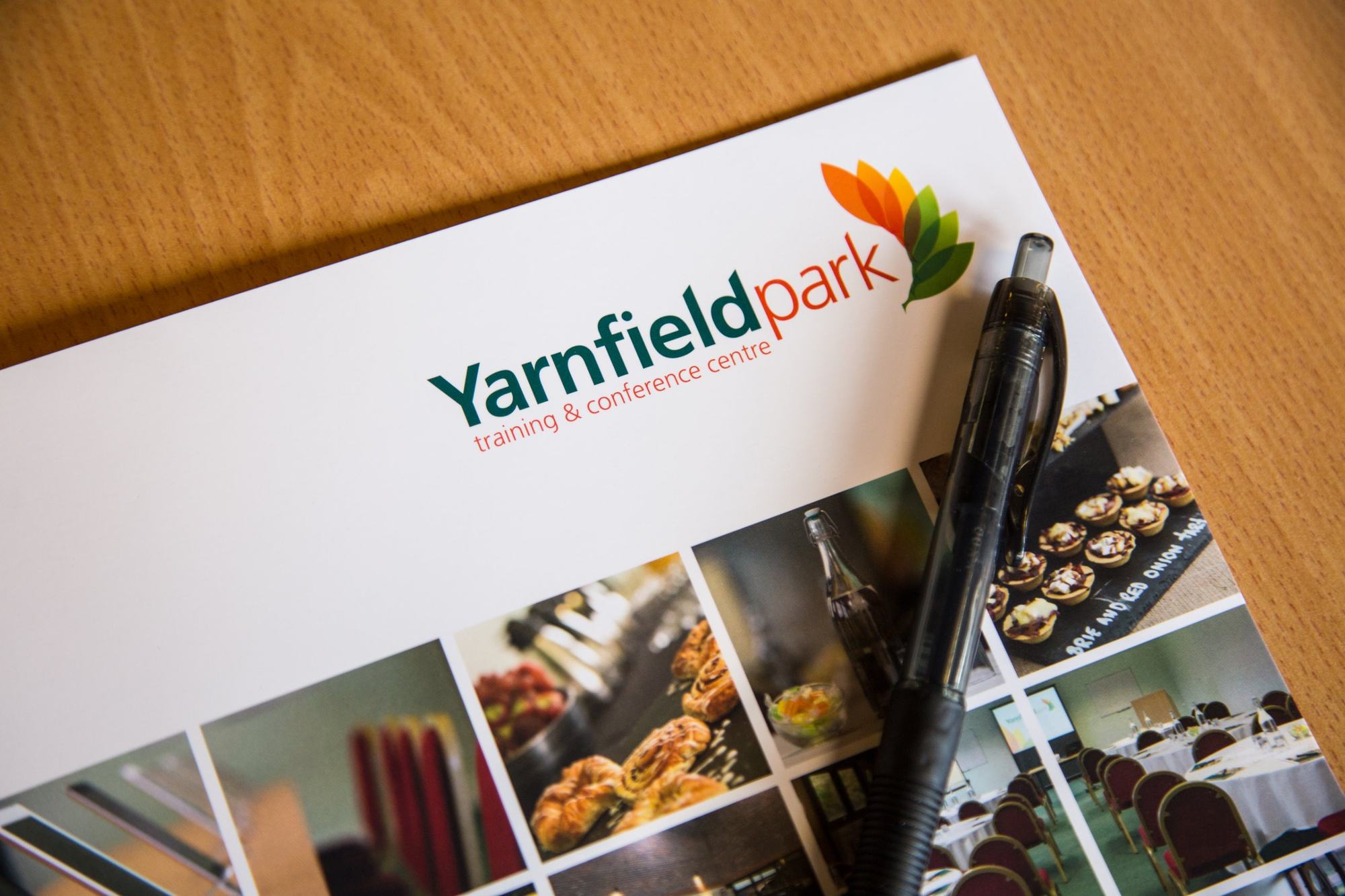 Printed brochure with pen on a desk