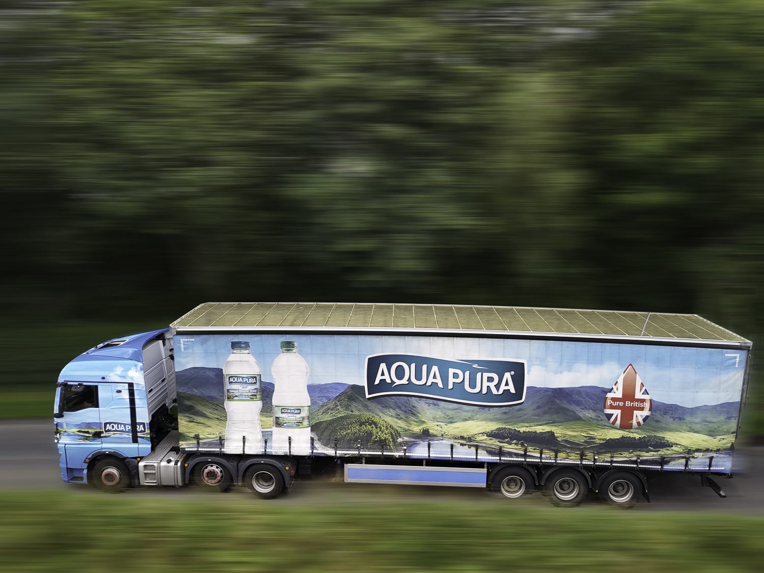 Branded lorry photographed on the move with a panning blur