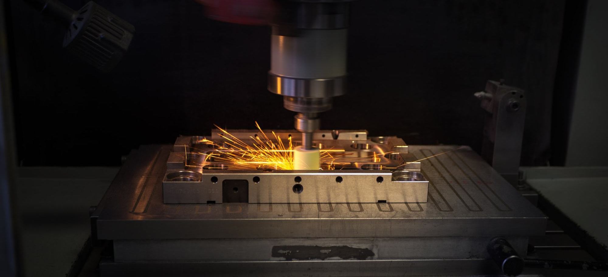 Sparks flying from a grinding machine in a factory