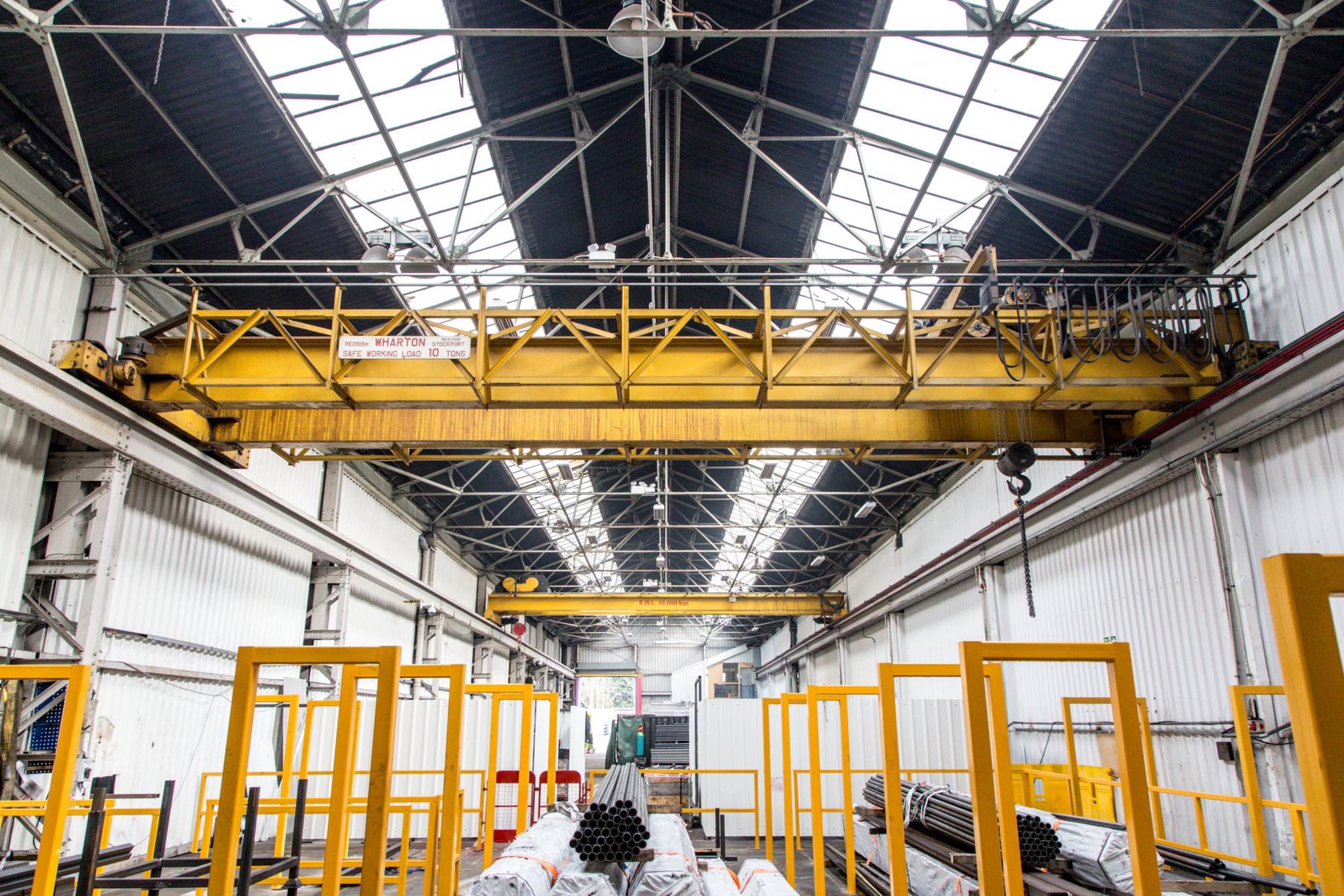 Factory hall with overhead gantry crane and skylights