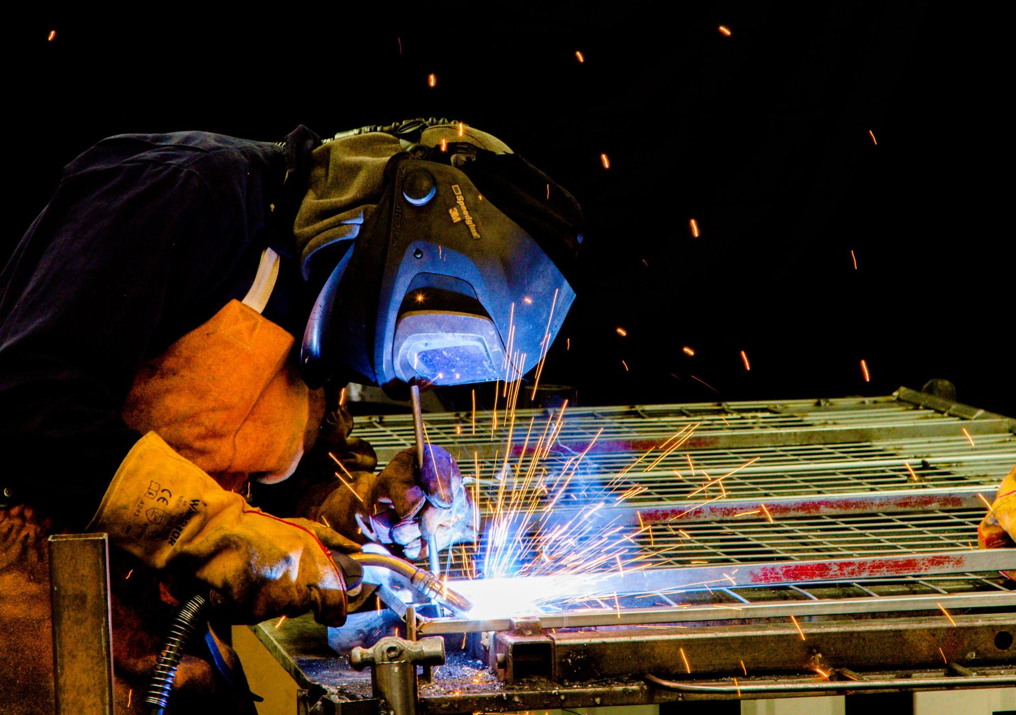 Welder at work in a shower of sparks