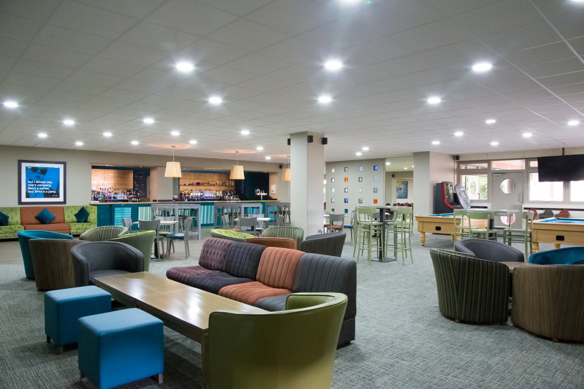 Colourful bar lounge with sofas and pool tables