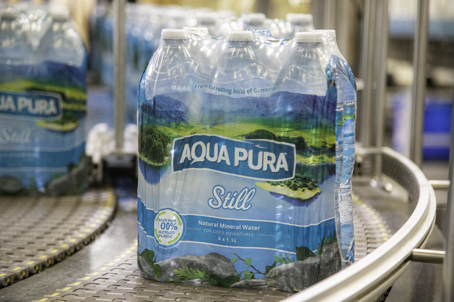 Multipacks of bottled water moving along the production line