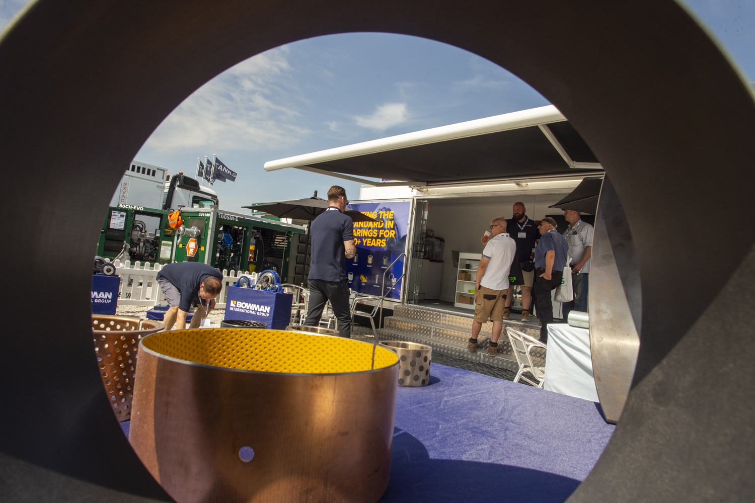 Exhibition stand framed through a large steel bearing